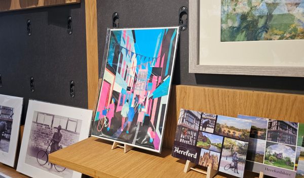 A shop display of paintings and artwork