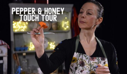 A woman wearing an apron holds out an orange flower Text reads Pepper and Honey Touch Tour