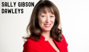 A close up of a woman smiling. Writing reads 'Sally Gibson Dawleys'
