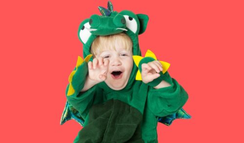 Zog Holiday Workshop  a young boy dressed as a dragon roars at the camera