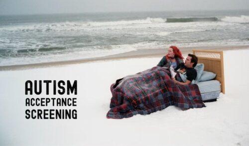 A man and a woman laid in a bed on a snowy beach The text on the left on reads Autism Acceptance Week