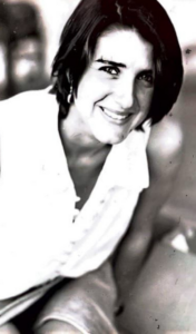 A black and white image of a woman smiling at the camera