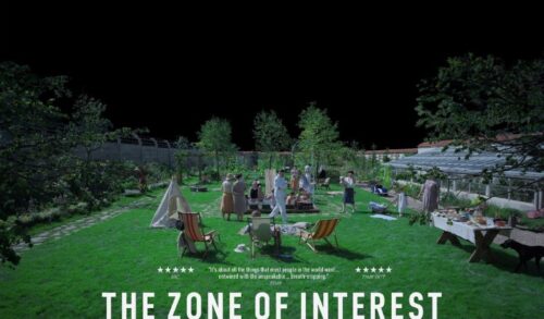 A family enjoys a garden party on a green lawn surrounded by a large wall The sky is entirely black The text reads The Zone of Interest