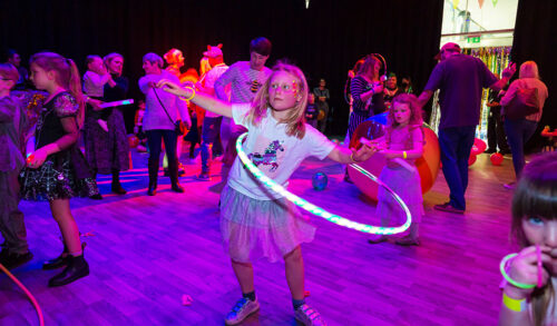 Family Rave  A young girl with a hula hoop dancing at a family rave