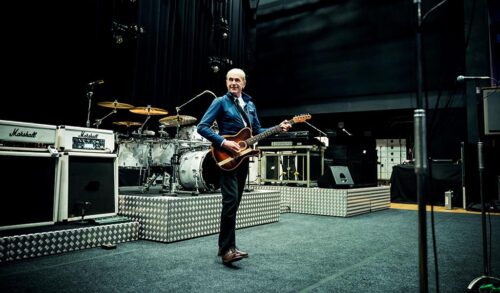 Francis Rossi performing on stage