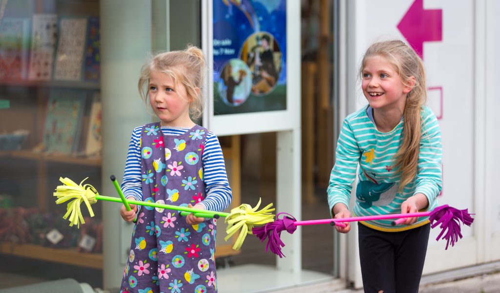 Two young girls learn circus skills