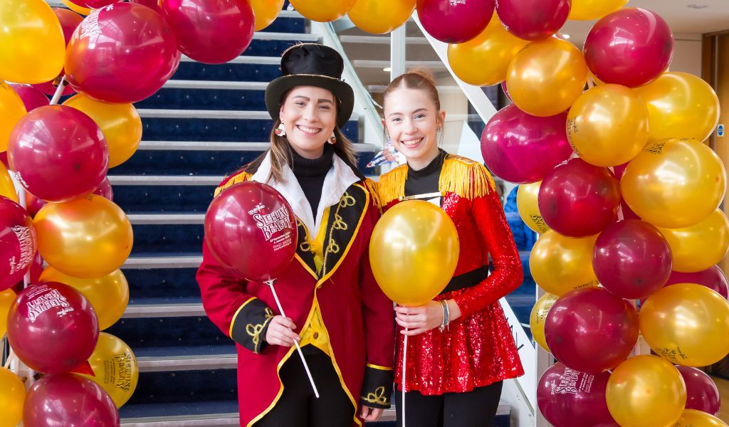 Two women dressed as circus ringmasters.