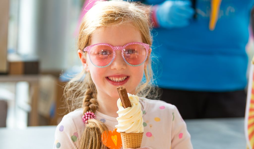 A young girl poses with an ice cream