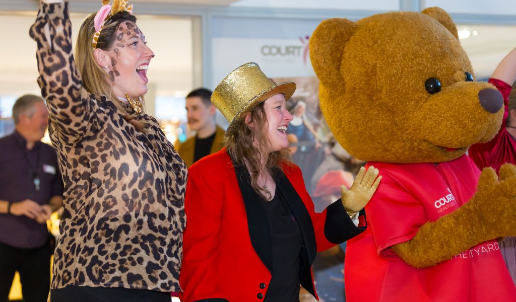 Three people looking happy dressed in costume.