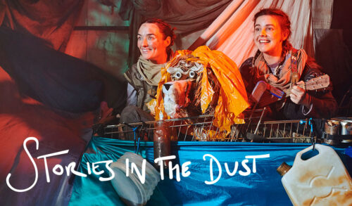 Stories In The Dust  two people in costume stand on a ship made out of recycled materials