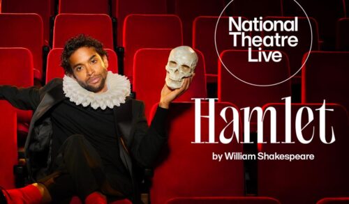 A man in a black suit and ruffled neck collar sits in a red velvet theatre seat whilst holding a skull in his left hand The text reads National Theatre Live Hamlet