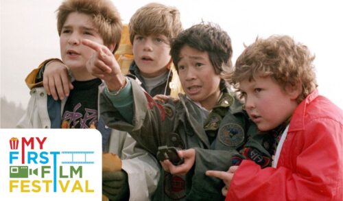 A group of four young boys stand pointing in a direction as they hold up an old treasure map and a compass In the bottom left is the My First Film Festival logo