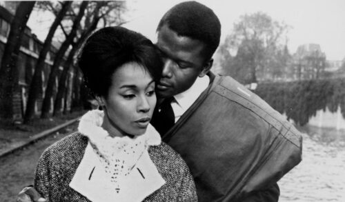 A blackandwhite image of a man embracing a woman outdoors