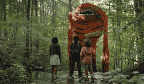 Three children in the woods looking at a giant imaginary monster