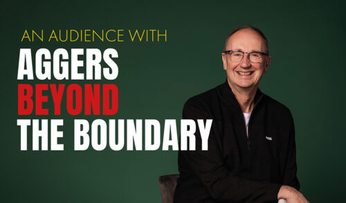 A man wearing glasses sat in a chair The text next to him reads An Audience with Aggers Beyond The Boundary
