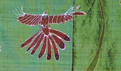 An embroidery of an eagle on a green fabric