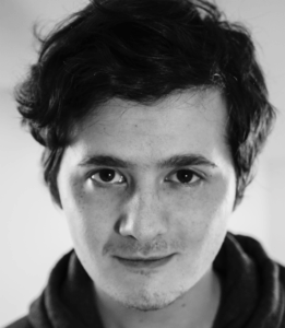 A black and white image of a young man.