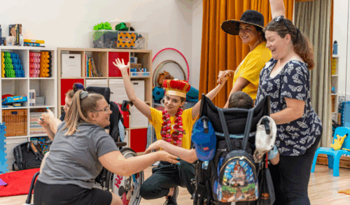 A group of young people smiling and laughing in fancy dress
