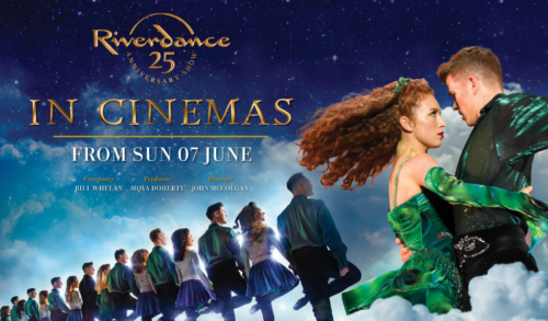 A man and a woman in green spin whilst dancing A line of Irish dancers are behind them
